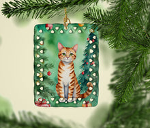 Load image into Gallery viewer, Safari Cat By the Christmas Tree Porcelain Ornament