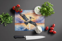 Load image into Gallery viewer, Pelican Fyling at Sunrise Glass Cutting Boards – Durable, Decorative Kitchen Art