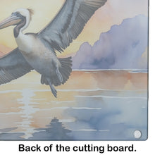 Load image into Gallery viewer, Pelican Fyling at Sunrise Glass Cutting Boards – Durable, Decorative Kitchen Art