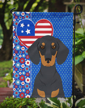 Load image into Gallery viewer, Black and Tan Dachshund Patriotic Heart Garden Flag – Red, White &amp; Blue Dog Decor with Star Background