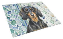 Load image into Gallery viewer, Longhaired Black and Tan Dachshund Coastal Sea Glass Glass Cutting Board