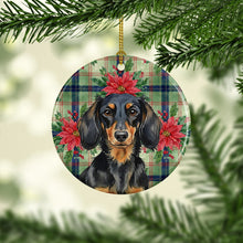 Load image into Gallery viewer, Longhaired Black and Tan Dachshund Christmas PoinsettIas Ceramic Ornament