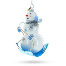 Load image into Gallery viewer, Snowman Riding a Sled Glass Christmas Ornament