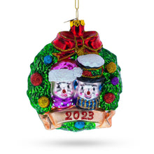 Load image into Gallery viewer, 2023 Snowmen Couple in Wreath Glass Christmas Ornament