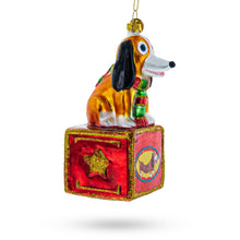 Load image into Gallery viewer, Playful Toy Dog on Festive Red Box Glass Christmas Ornament