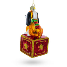 Load image into Gallery viewer, Playful Toy Dog on Festive Red Box Glass Christmas Ornament