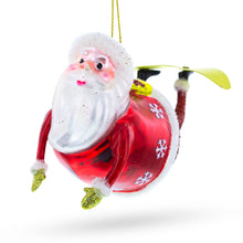 Load image into Gallery viewer, Santa Snowboarding Glass Christmas Ornament