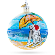Load image into Gallery viewer, Santa Hat Relaxing at Beach Glass Ball Christmas Ornament 4 Inches