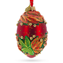 Load image into Gallery viewer, Red and Green Leaves on Red Glass Egg Ornament 4 Inches